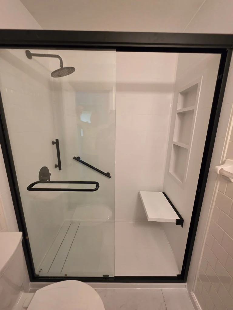 Walk-in shower installation in Chesapeake Beach MD featuring white wall panels and accessibility upgrades