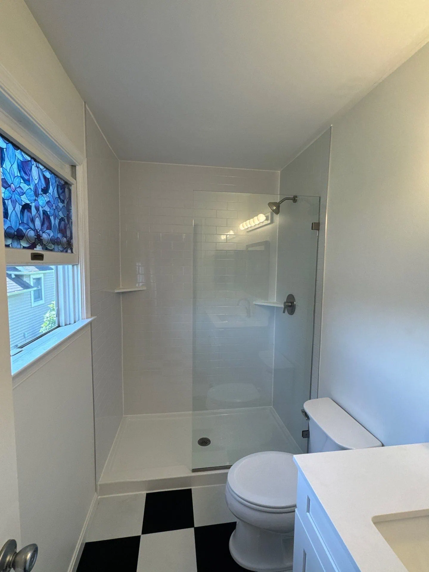 Modern bathroom remodel in Deale MD featuring subway tile wall surrounds and updated fixtures